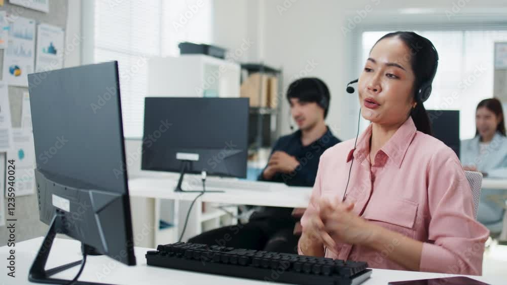 Asian woman call center agent, customer service, tech support with headphones working on computer for online consultant, assistance, customer support in call center office. Telemarketing and Business Asian woman call center agent, customer service, tech support with headphones working on computer for online consultant, assistance, customer support in call center office. Telemarketing and Business
