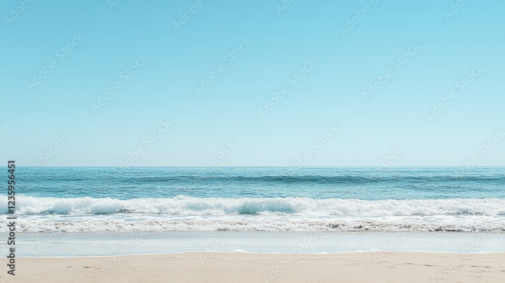 Fototapeta premium Tranquil Beach Scene with Soft Sand, Gentle Waves, and Clear Blue Sky Featuring a Peaceful and Relaxing Coastal Environment Ideal for Beach-Themed Content and Vacation Imagery