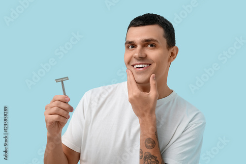 Smiling young man holding a...