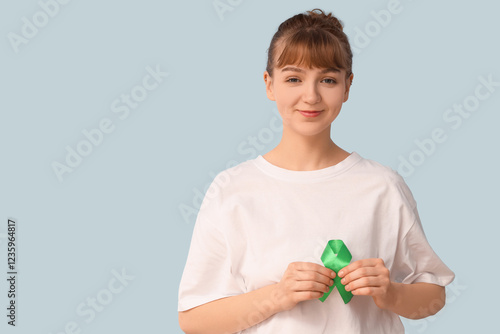Young woman with green ribb...