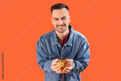 Handsome man with cup of le...