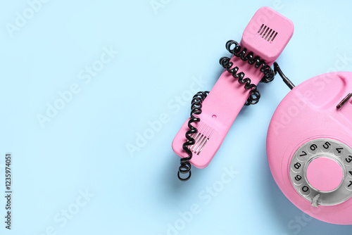 Pink retro telephone on blu...