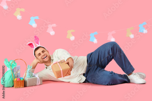 Happy young man in bunny ea...