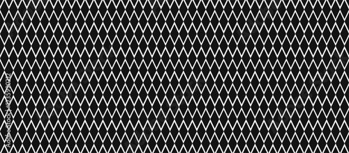 Seamless harlequin or argyle pattern with black diamonds on a white background, creating a classic geometric design. Vector illustration.