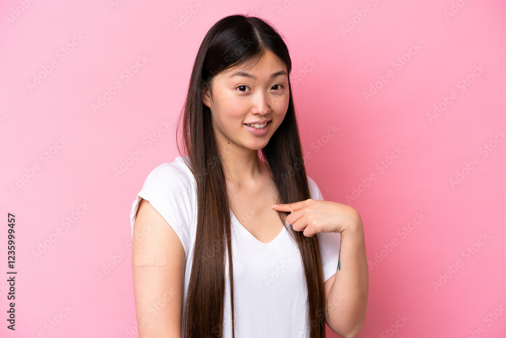 Young Chinese woman wearing a band aids isolated on pink background with surprise facial expression Young Chinese woman wearing a band aids isolated on pink background with surprise facial expression