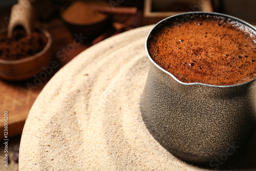 Cezve with coffee in sand o...