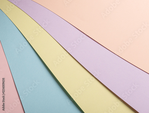 Pastel abstract geometric paper background with striped patterns in pink, blue, yellow, lavender, and peach. The multicolored minimalist design features soft tones, a soothing gradient, and a stylish photo