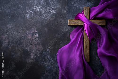 Christianity cross wrapped with purple clothes with copy space