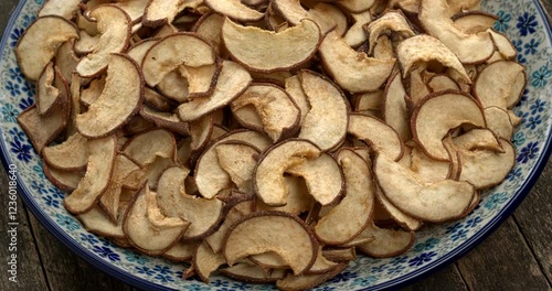 Dried Asian pear slices on a plate. Table spin.  photo