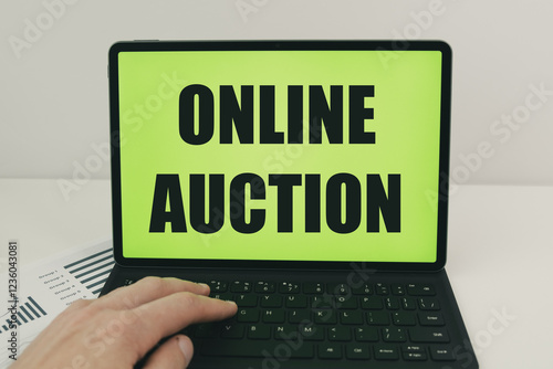 the concept of an online auction with text on a laptop screen photo