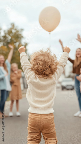 Joyful caucasian child celebrating outdoors with family and friends