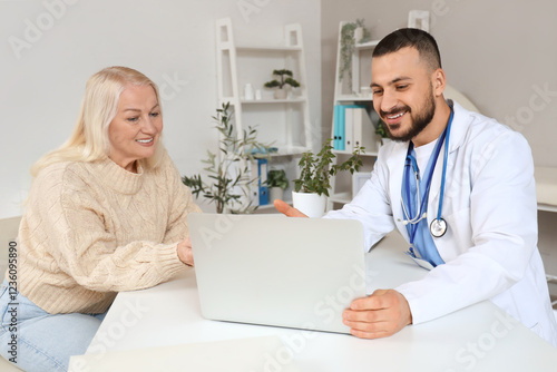 Male doctor with mature wom...