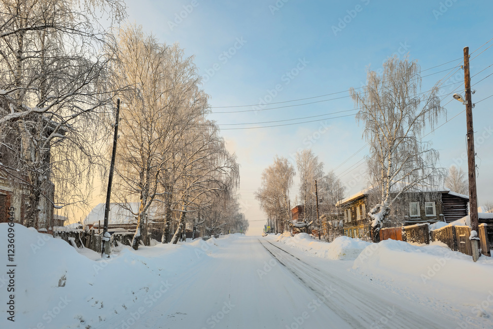 Fototapeta premium Slippery winter road. Winter evening village.