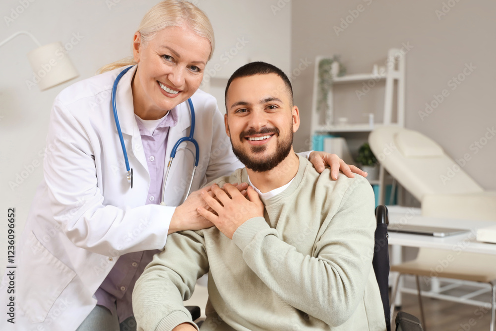 Female doctor hugging young man in wheelchair at hospital