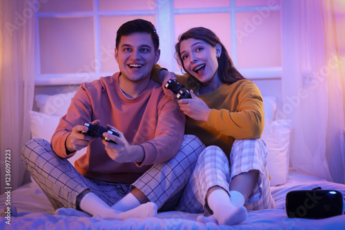 Young couple playing video ...