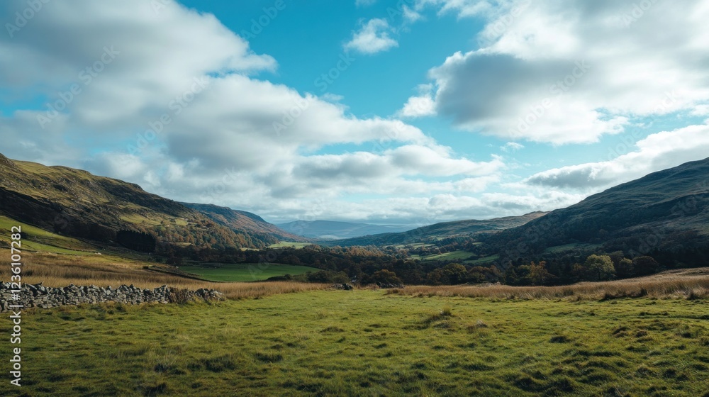 Obraz premium Majestic Mountain Valley Landscape with Clouds and Green Meadows