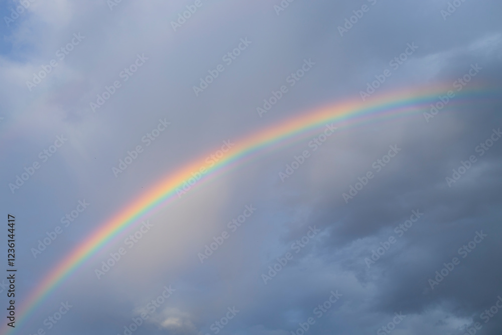 Dark clouds and rainbow in sunset sky. Amazing sky landscape. The sky gives happiness, calmness and peace Dark clouds and rainbow in sunset sky. Amazing sky landscape. The sky gives happiness, calmness and peace