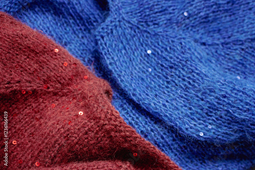 Obraz na płótnie Red and blue knitted sweater with sequins. Sequinned knitwear. Sequin pattern in needlework. Knitting hobby. Knitter work. Sequins texture in knitwear. Bright knitted fashion for holidays. w salonie