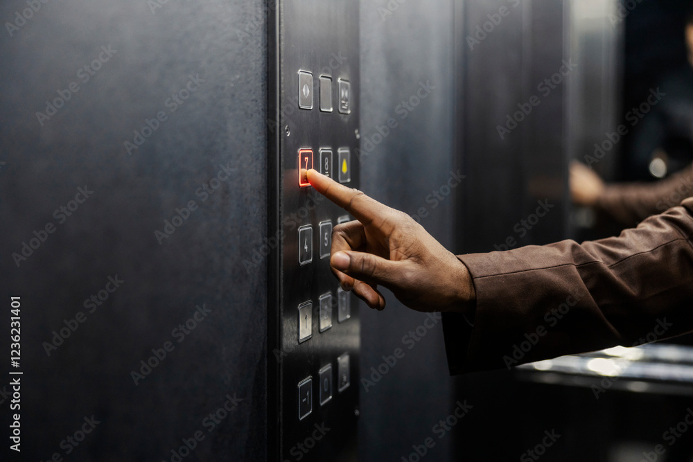 Close up of diverse man's hand pressing button in elevator. Close up of diverse man's hand pressing button in elevator.