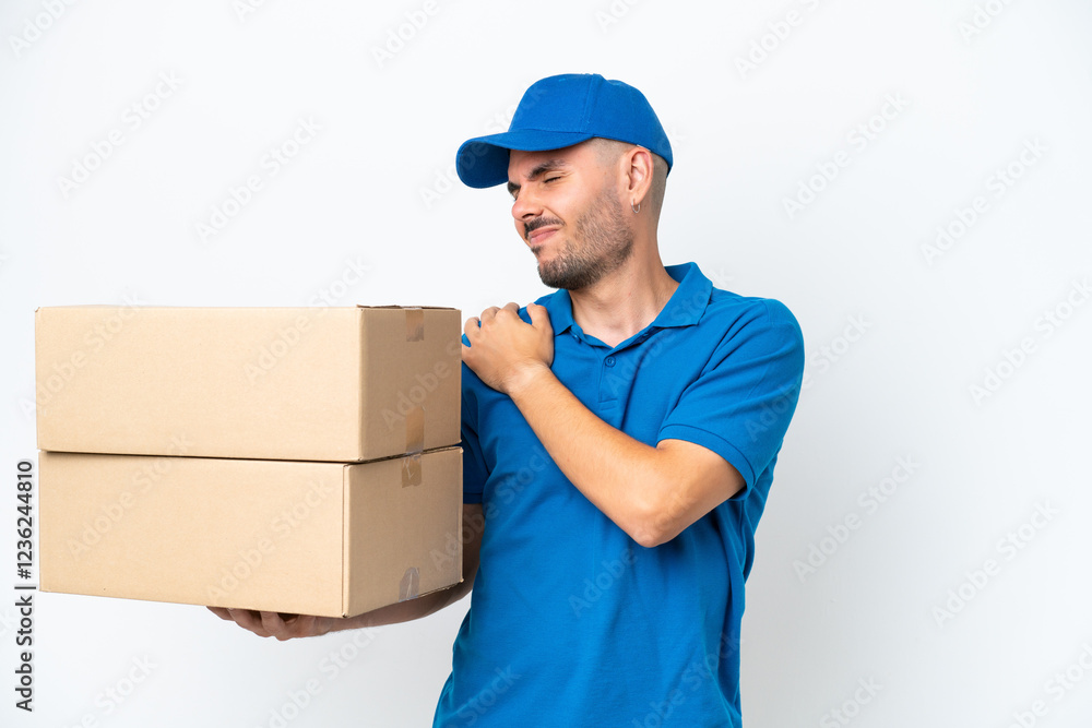 Delivery caucasian man isolated on white background suffering from pain in shoulder for having made an effort Delivery caucasian man isolated on white background suffering from pain in shoulder for having made an effort