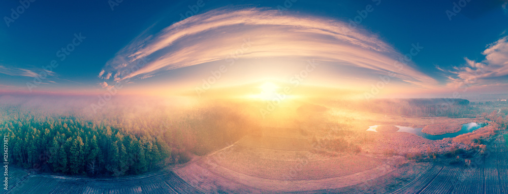 Amazing countryside panorama on an early misty morning with incredible light and a beautiful cloudy sky. Countryside in the morning. Drone view. Horizontal banner