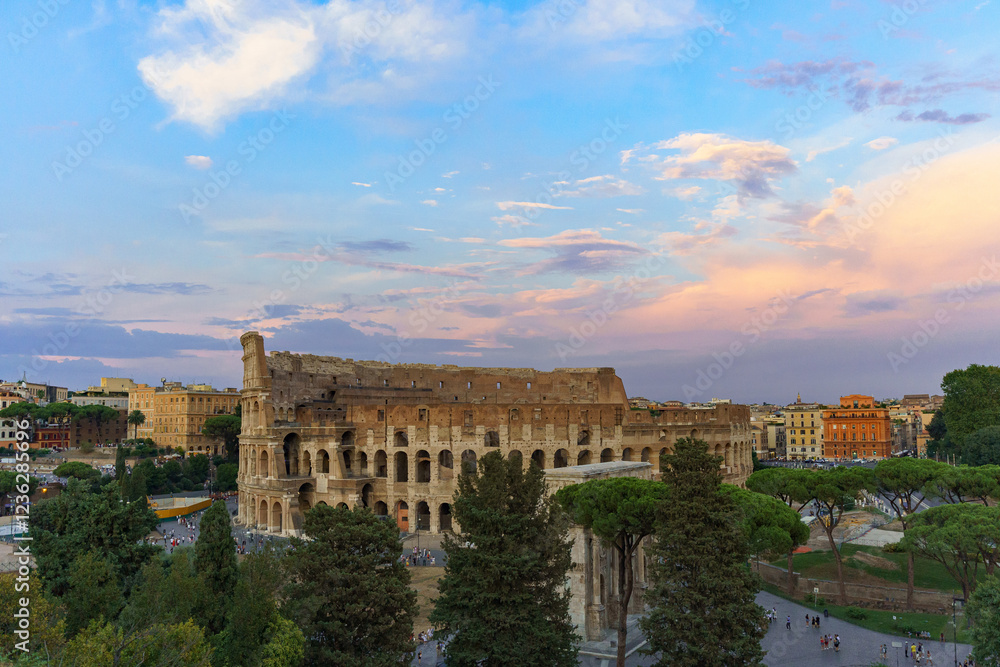 Fototapeta premium The great Roman Colosseum also known as the Flavian Amphitheater on a sunny day with deep blue sky, beautiful clouds and no people visible 