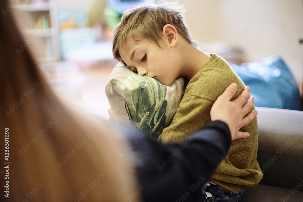 Fototapeta premium Anxiety, bullying and hand of mother with boy hugging pillow for comfort, compassion and empathy at home. Disability, abuse and mom with sad child suffering depression or mental health problem