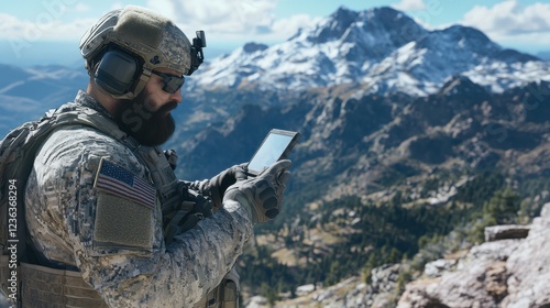 Soldier using tablet device in mountainous terrain
