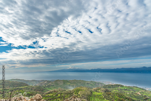 Panorama dell'Etna innevato con cielo nuvoloso che sovrasta lo stretto photo