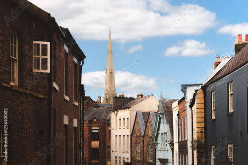 Fototapeta Charming view of Durham's historic old town architecture and St Nicholas’ Church steeple under a bright summer sky