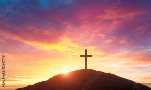 wooden cross atop hill during stunning sunset, with vibrant colors illuminating sky, creating serene and peaceful atmosphere