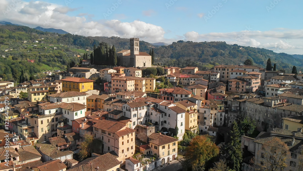 Naklejka premium Aerial view of Barga, Garfagnana, showcasing the picturesque Italian village on a sunny day