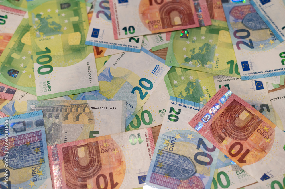 Fototapeta premium Euro banknotes scattered on table 