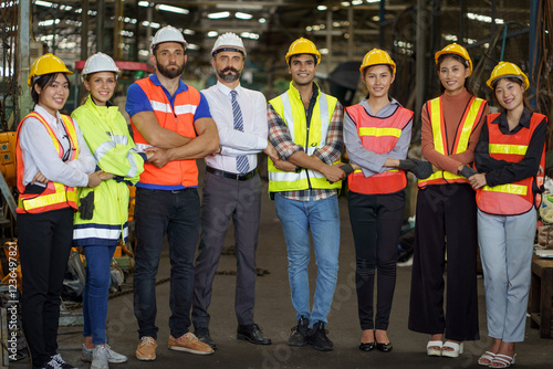 group of diversity engineer factory worker standing in row holding hand  with business man manager or executive boss leader team together in industry manufacturing warehouse.