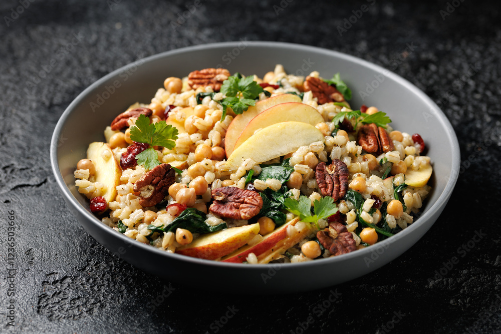Warm barley pearl salad with kale, dried cranberries, apples and roasted pecan nuts. Healthy food Warm barley pearl salad with kale, dried cranberries, apples and roasted pecan nuts. Healthy food