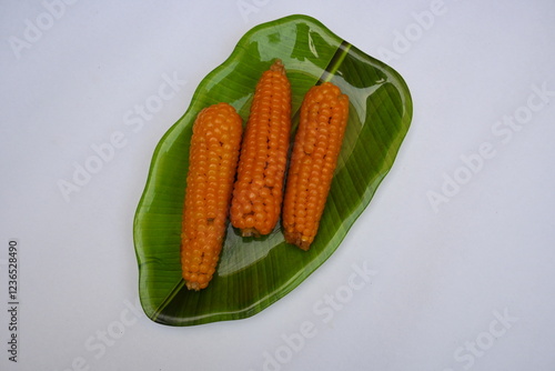 Boiled sweet corn on the plate. This is a complete food for humans. It contains many vitamins, such as Vitamin B1, B5, C, B9, E, A. Boiled corn on the cob. It's like all over world.  Heathy eating.  photo