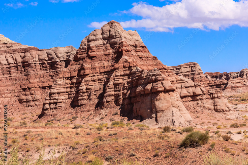 A rocky mountain range with a clear blue sky in the background A rocky mountain range with a clear blue sky in the background
