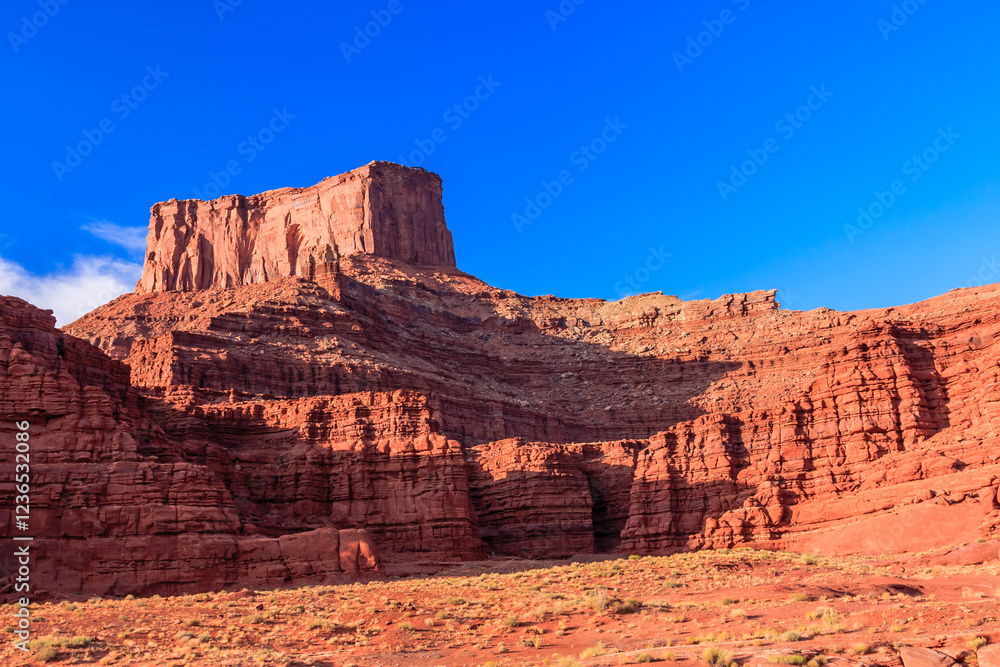 A rocky mountain range with a blue sky in the background