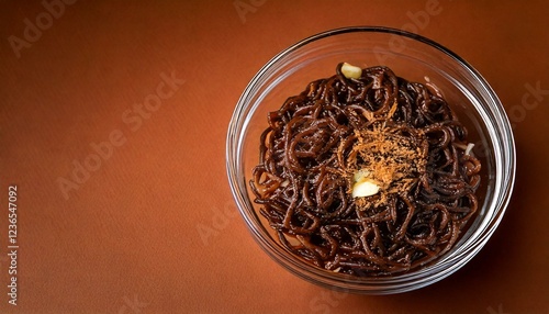 Jajangmyeon food on transparent bowl, isolated brown background, copy space  photo