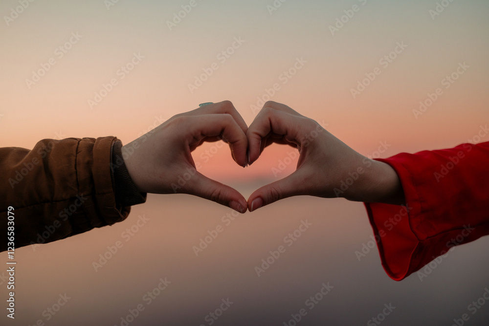 Hands Holding Heart-Shaped Object in Romantic Sunset or Sunrise Setting Hands Holding Heart-Shaped Object in Romantic Sunset or Sunrise Setting