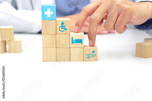 Two fingers of doctor is walking up stairs wooden blocks with medical symbol icons. Concept of Success, progress and growth.