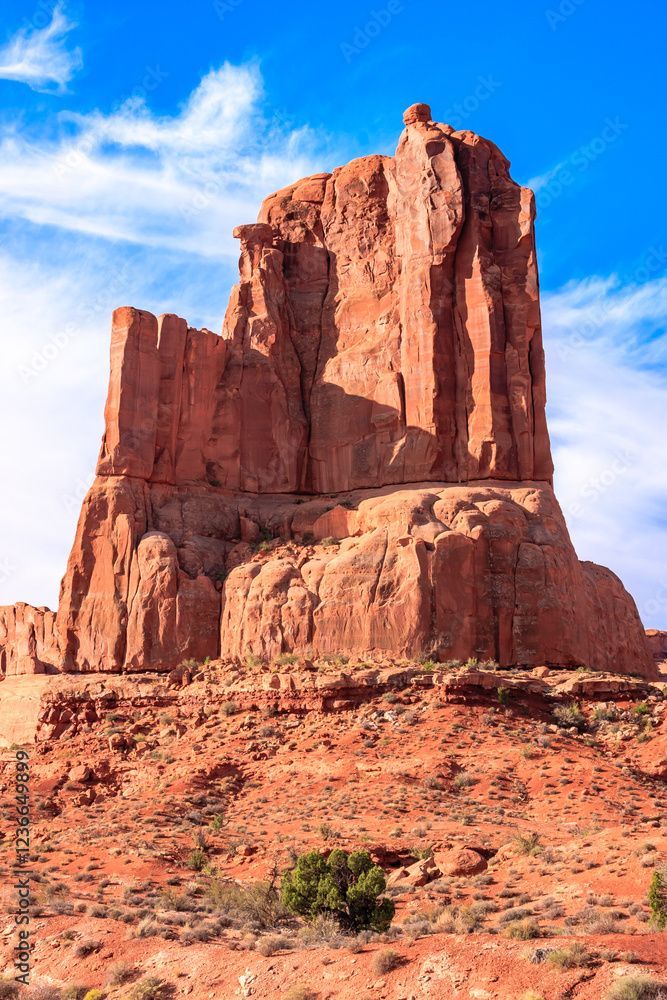 A large rock formation sits on a hillside in the desert A large rock formation sits on a hillside in the desert