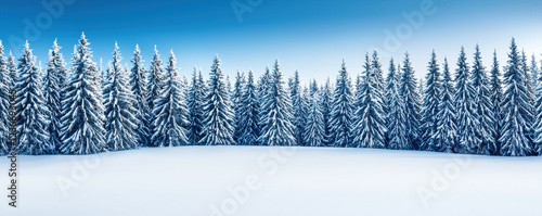 Snow-covered landscape with pine trees under clear blue sky showcasing winter serenity in a forested area photo