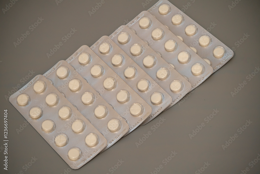 Tablets arranged in multiple strips on a neutral background Tablets arranged in multiple strips on a neutral background