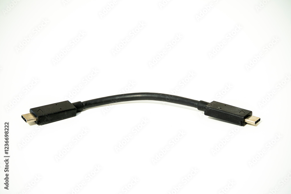 USB cable connecting devices in a tech workspace setup USB cable connecting devices in a tech workspace setup