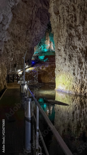 A serene underground river flows through a dimly lit cave, perfect for exploring natural wonders on a unique adventure tour  stopica pecina  Stopica cave photo