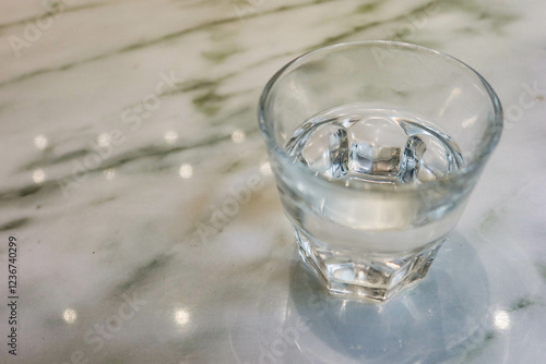 Wallpaper Mural close up of transparent glass of water on a marble table Torontodigital.ca