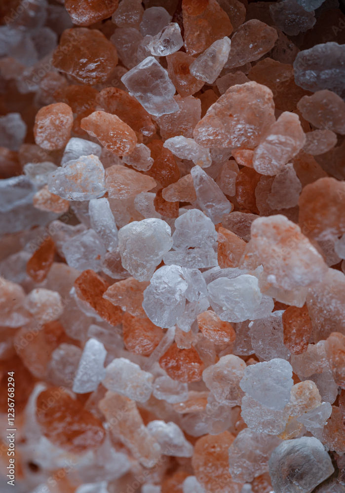 Close-up view of Pink Himalayan Salt on Bright colors textured surface. Crystals and crushed blocks of natural pink salt in the background, Chipped Himalayan salt stone, use it as your Space for text,