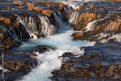 Scenic Bruarfoss Waterfalls Flowing Over Lava Fields in Sunset Light