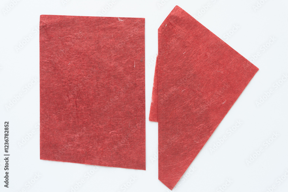 Fototapeta premium two sheets of textured red paper on white